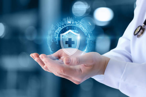 The Doctor Shows The Icon Of The Protection Of Health On Blurred Background.